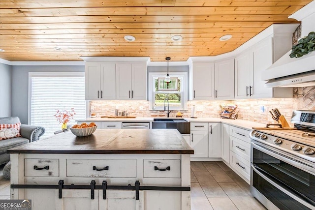 kitchen with appliances with stainless steel finishes, pendant lighting, white cabinets, and wood ceiling