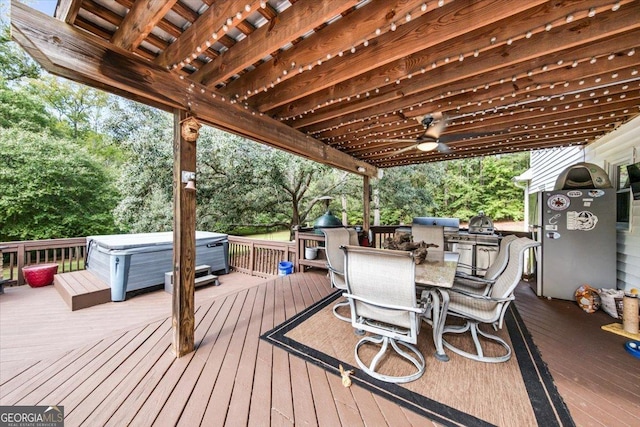 wooden terrace featuring ceiling fan and a hot tub