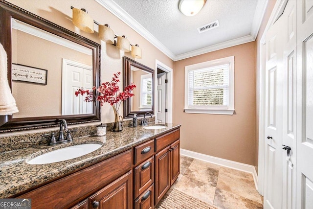 bathroom with vanity, a textured ceiling, and crown molding