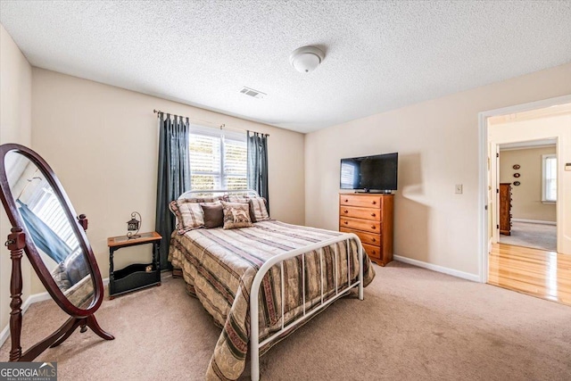 carpeted bedroom with a textured ceiling