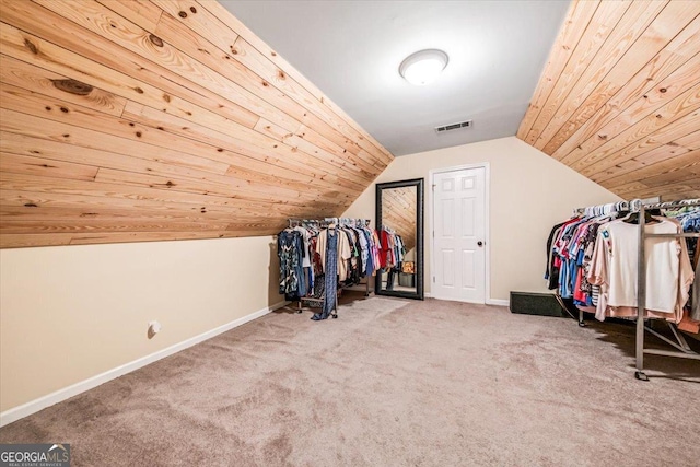 walk in closet with lofted ceiling and carpet floors