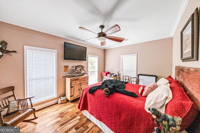 bedroom with ornamental molding, light hardwood / wood-style floors, and ceiling fan