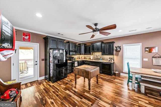 kitchen with black appliances, light hardwood / wood-style flooring, ornamental molding, ceiling fan, and backsplash