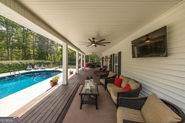 view of swimming pool featuring an outdoor hangout area, a diving board, and ceiling fan