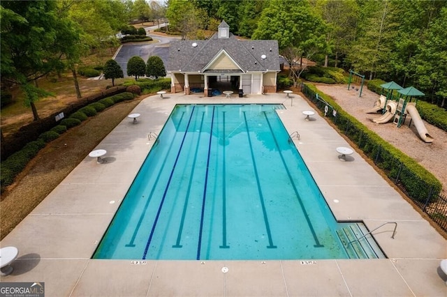 view of pool featuring a patio area and a playground