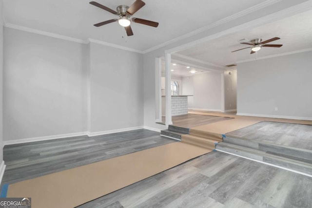 unfurnished living room with ceiling fan, ornamental molding, and wood-type flooring