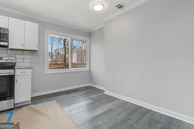 kitchen featuring white cabinetry, ornamental molding, stainless steel appliances, and dark wood-type flooring