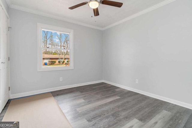 empty room featuring dark hardwood / wood-style flooring, crown molding, and ceiling fan