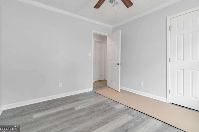 unfurnished bedroom featuring crown molding, ceiling fan, and light hardwood / wood-style flooring