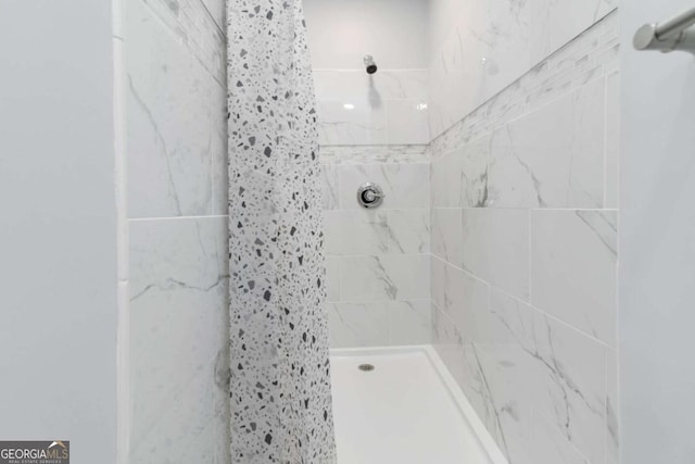 bathroom with tiled shower