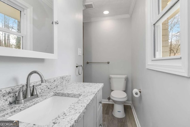 bathroom featuring crown molding, wood-type flooring, toilet, and vanity