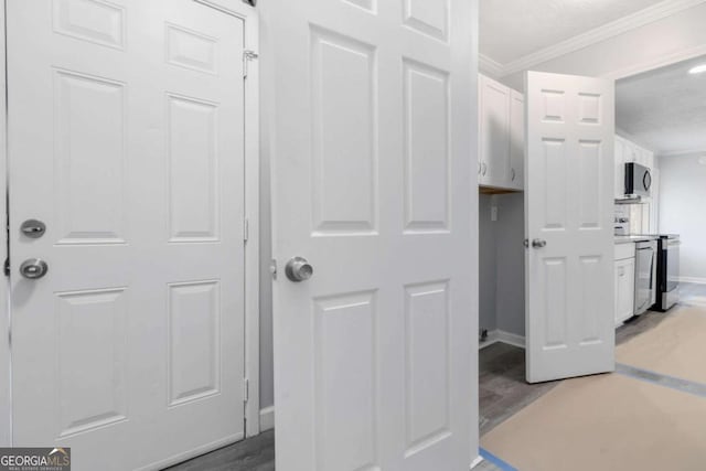 interior space with crown molding and dark hardwood / wood-style flooring