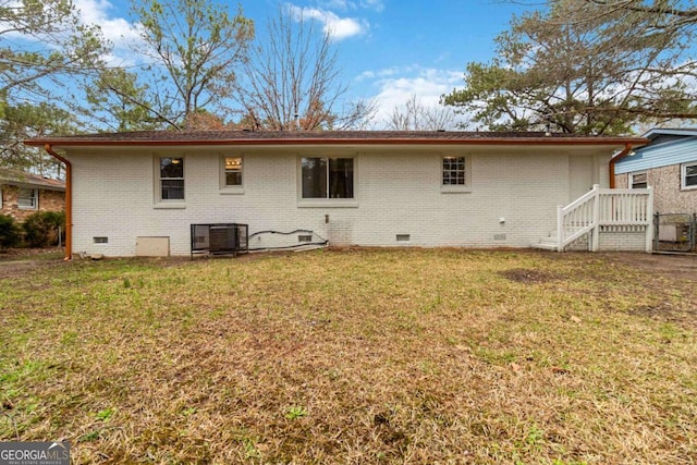 back of house with a yard and central AC unit