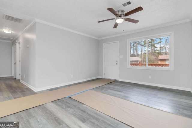 interior space with ceiling fan, ornamental molding, and hardwood / wood-style floors