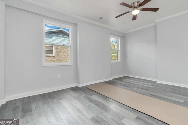 empty room with crown molding, ceiling fan, and hardwood / wood-style flooring