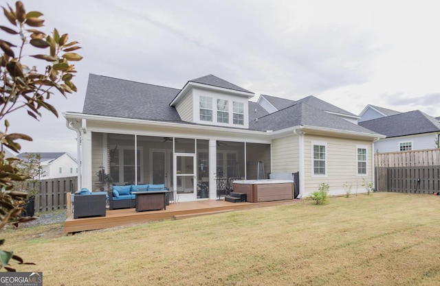 back of house with a wooden deck, outdoor lounge area, a yard, a hot tub, and a sunroom