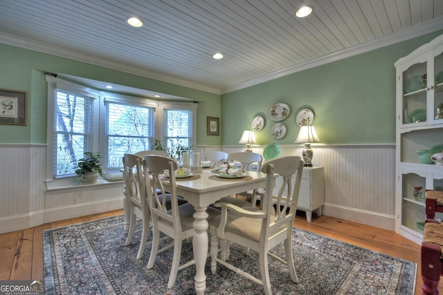 dining area featuring wood ceiling, ornamental molding, and hardwood / wood-style floors