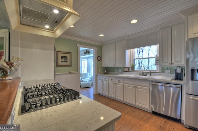 kitchen with white cabinetry, appliances with stainless steel finishes, and butcher block countertops