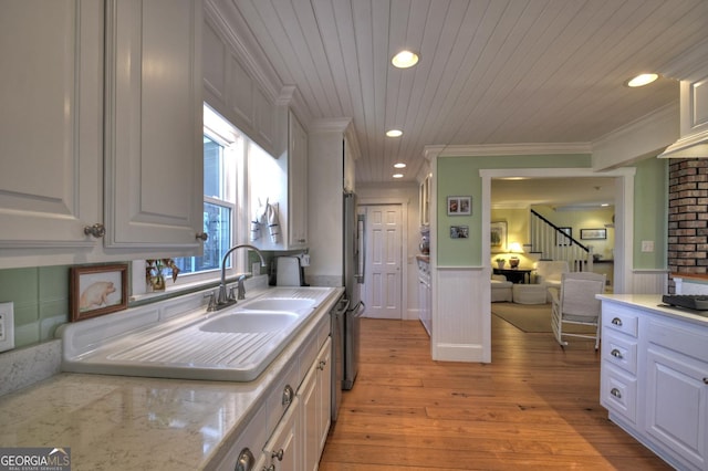 kitchen with white cabinets, ornamental molding, light stone countertops, wooden ceiling, and light wood-type flooring