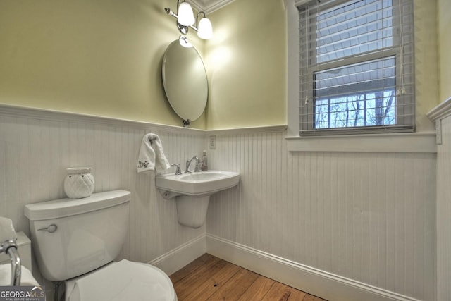 bathroom with hardwood / wood-style floors and toilet