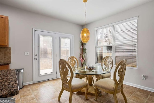 dining space featuring baseboards