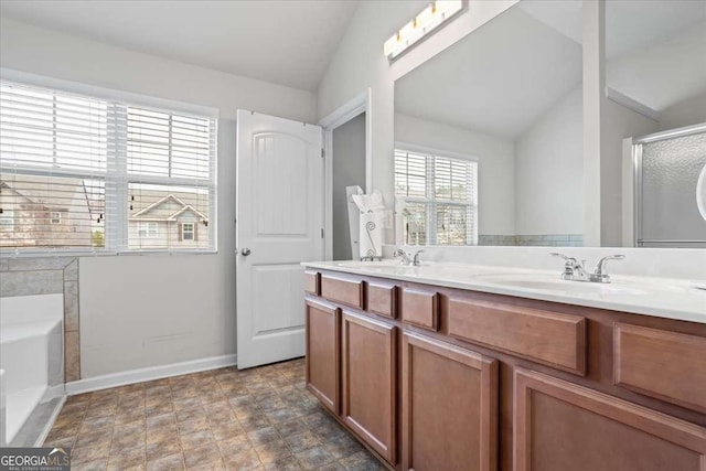 bathroom featuring lofted ceiling, vanity, and shower with separate bathtub