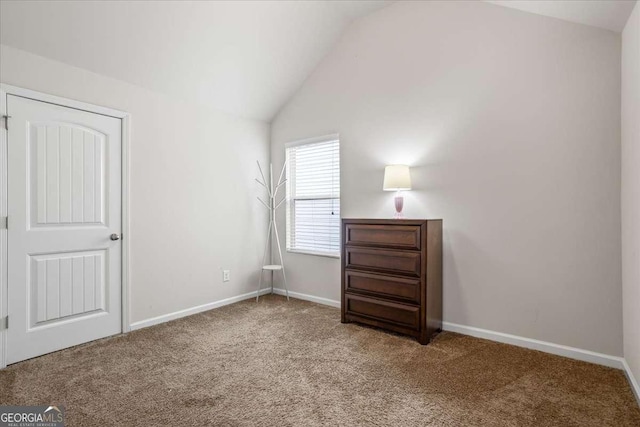 unfurnished bedroom with lofted ceiling and carpet flooring