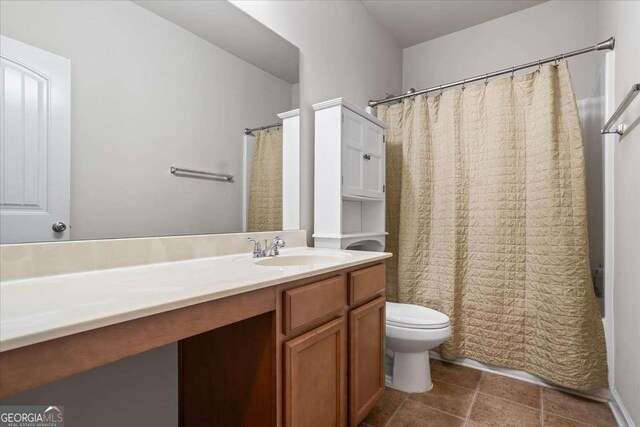 bathroom with vanity, a shower with curtain, tile patterned floors, and toilet