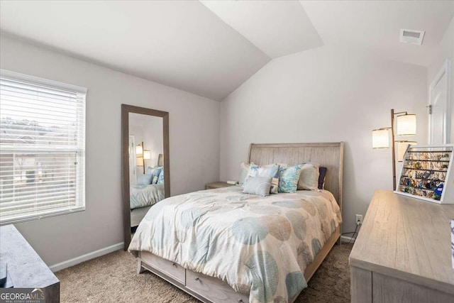 carpeted bedroom featuring lofted ceiling