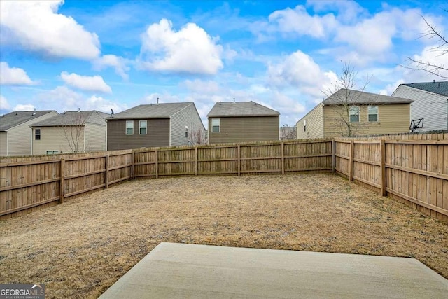 view of yard with a residential view and a fenced backyard