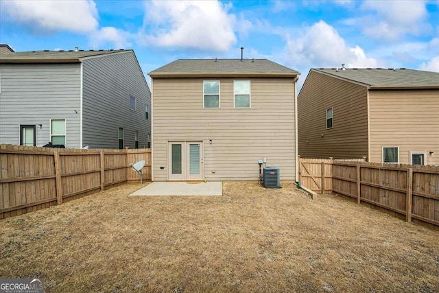 rear view of property featuring cooling unit, a fenced backyard, and a patio