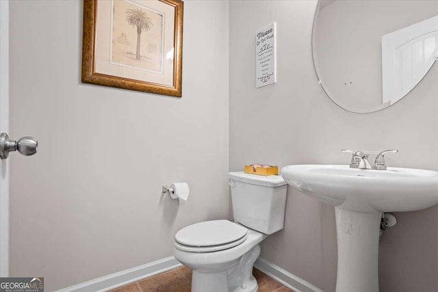 bathroom featuring toilet and tile patterned flooring