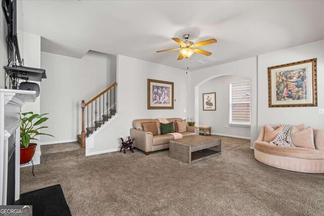 carpeted living room featuring ceiling fan