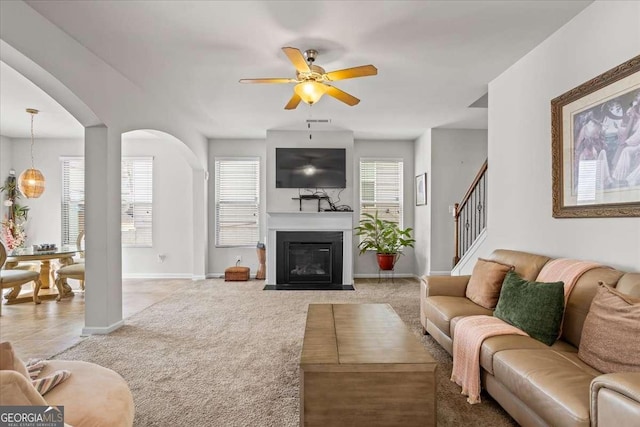 living room featuring light colored carpet and ceiling fan