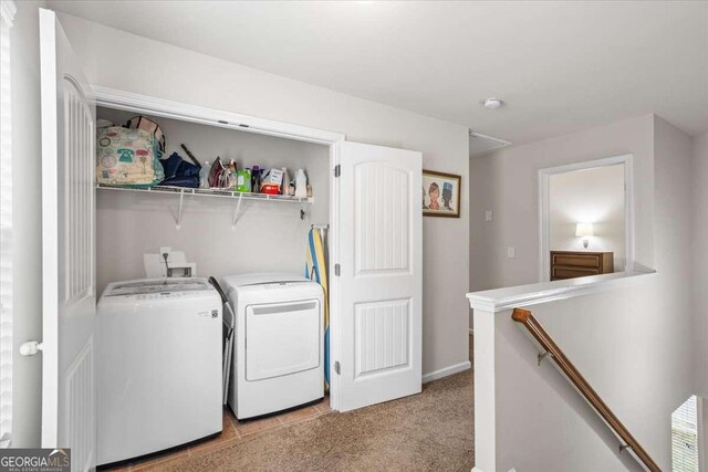 laundry room featuring separate washer and dryer and light carpet