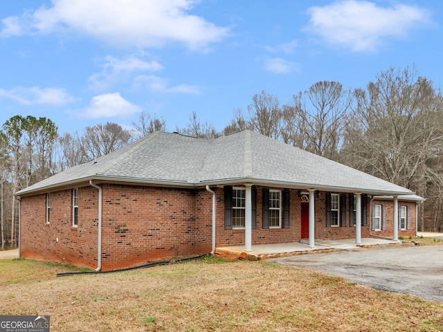 exterior space featuring a porch and a front lawn