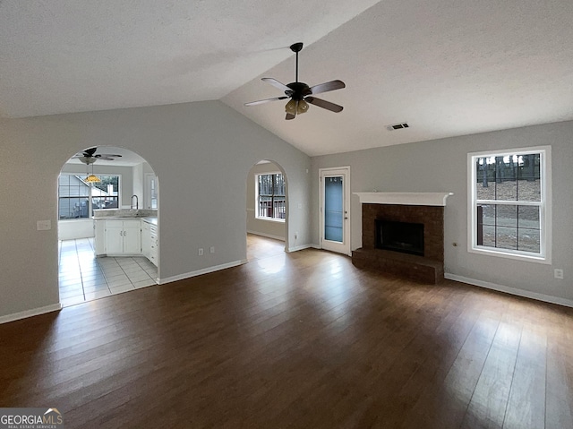 unfurnished living room with ceiling fan, a healthy amount of sunlight, and light hardwood / wood-style floors