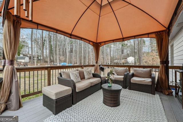 wooden terrace featuring a gazebo and an outdoor hangout area