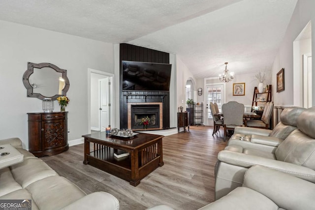 living room with hardwood / wood-style floors, a fireplace, and a textured ceiling