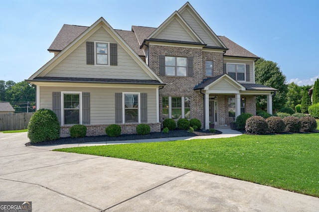 craftsman-style house with a front yard and a porch