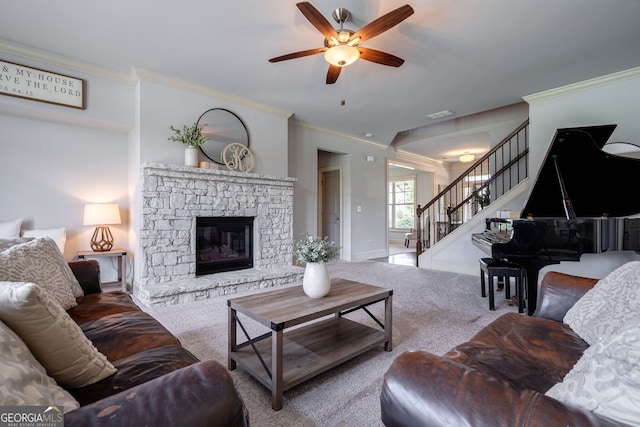 carpeted living room with crown molding, ceiling fan, and a fireplace