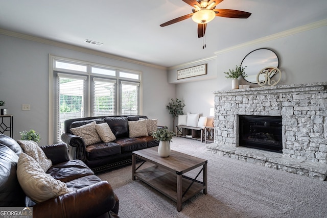 carpeted living room featuring ornamental molding, ceiling fan, and a fireplace