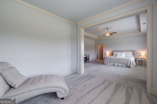 bedroom with ceiling fan, carpet flooring, ornamental molding, and a tray ceiling