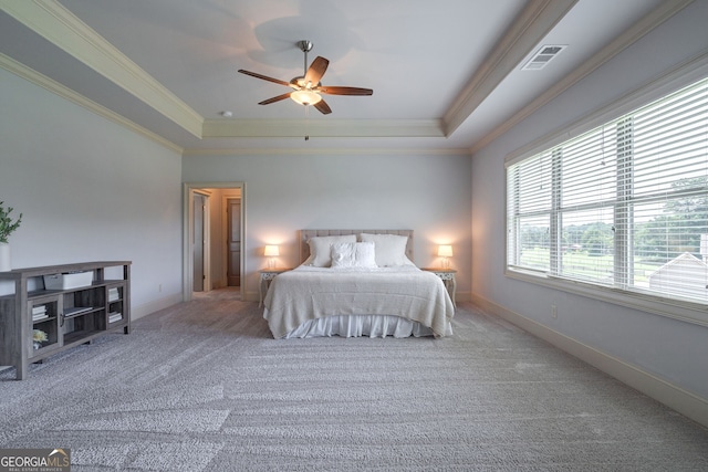 bedroom with a raised ceiling, crown molding, carpet floors, and ceiling fan