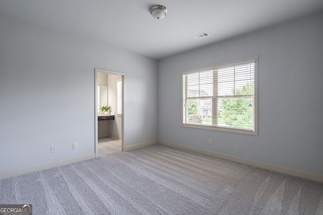 spare room with light colored carpet