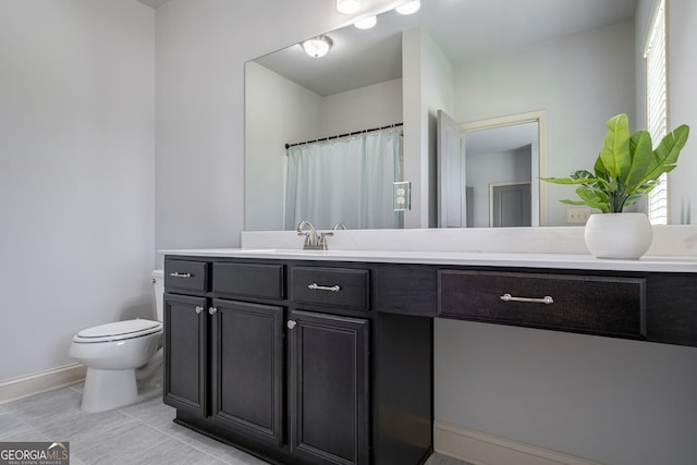 bathroom featuring tile patterned floors, vanity, and toilet