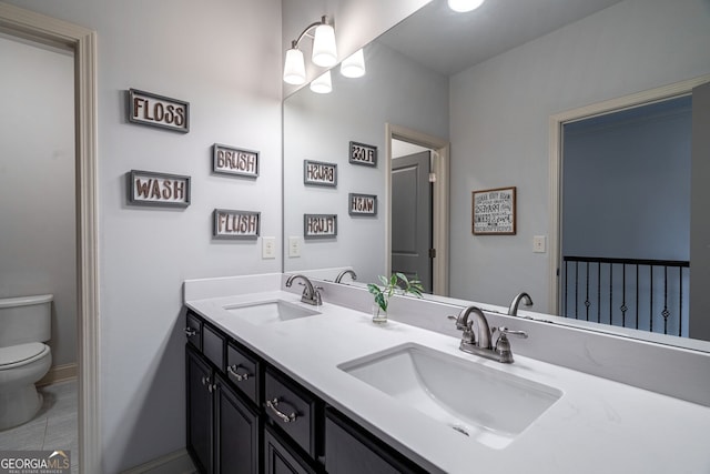 bathroom featuring vanity and toilet