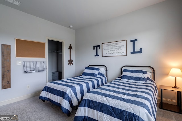 carpeted bedroom featuring a walk in closet and a closet