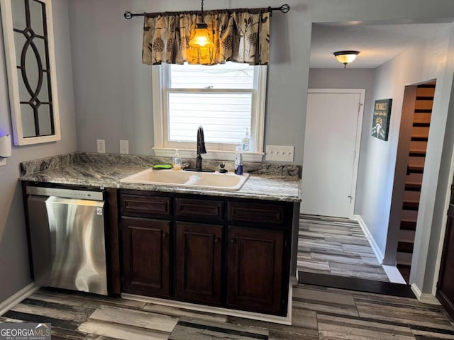 kitchen with dark brown cabinetry, sink, light wood-type flooring, dishwasher, and pendant lighting