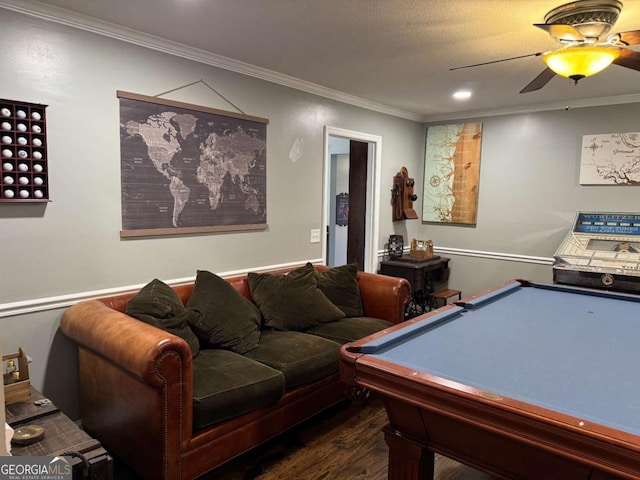 rec room with pool table, dark wood-type flooring, ornamental molding, and ceiling fan